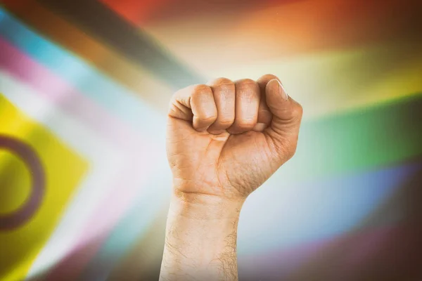 背景に進歩の旗を持つLgbtコミュニティに自由と平等を要求する握りこぶしを手渡す — ストック写真