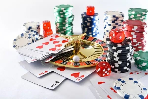 Casino games background isolated on white background with playing cards, betting chips and dice for playing various games of chance. Elevated view.