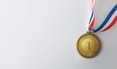 Bir numaralı işlemeli altın metal madalya ve beyaz arka planda mavi beyaz ve kırmızı renkli kurdele. Üst görünüm.