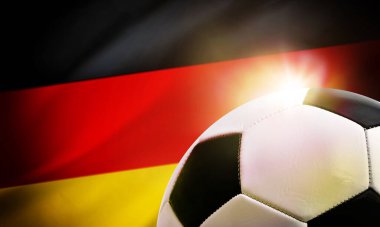Almanya futbolunun arka planında top ve ülkenin bayrağı var.