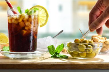 Mutfakta, içi yiyecek ve bir bardak sodayla dolu ahşap bir bankta atıştırmak. Ön görünüm.