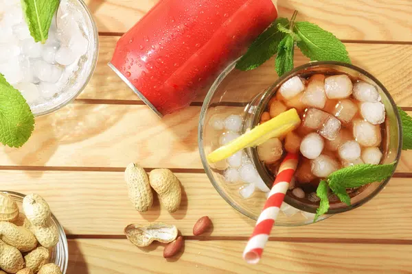 Plaj masasında bir sürü buzla dolu bardakta kola ve güneşli bir günde aperatif. Üst görünüm.