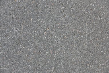 Orta gri renkte kirli asfalt detaylarının makro arkaplanı. Üst görünüm.