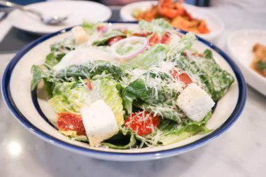 Sezar salatası ya da domuz pastırmalı sebze salatası ve haşlanmış yumurta, ekmek ve peynir servis etmek için.