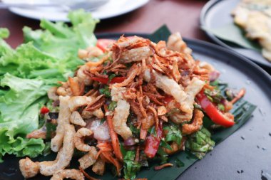 spicy salad , pork crackling salad or pork rind salad or Thai spicy  salad or tea leaf salad for serve
