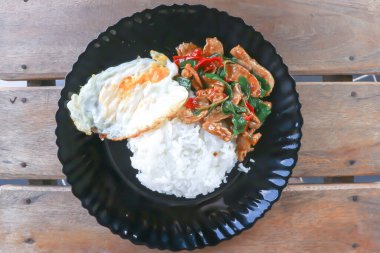 stir fried pork with chili, holy basil and rice with sunny side up egg for serve