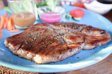 grilled pork or roasted pork , pork steak and salad