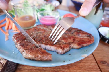 grilled pork or roasted pork , pork steak and salad