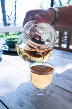 pour tea, pouring tea or a cup of tea on the table