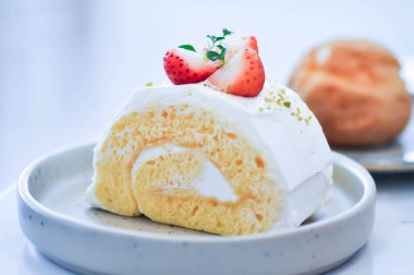 roll , cake roll or Swiss roll with strawberry topping