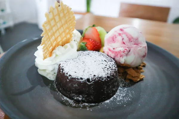 chocolate cake or chocolate lava cake with ice cream and fruit for serve