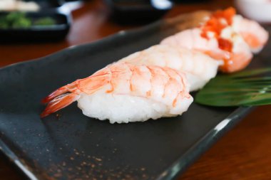 sushi or shrimp sushi or shrimp rolls, rice topped with shrimp or prawn rolls and salmon rolls or burnt salmon rolls