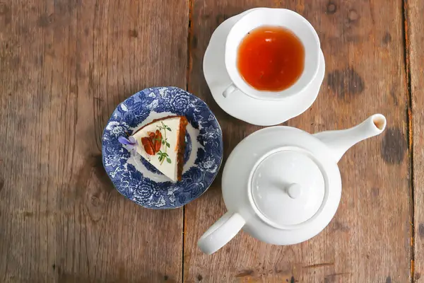 hot tea, English tea or tea cup and tea pot and carrot cake