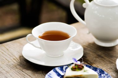 Sıcak çay, çay fincanı, çaydanlık ve kek.