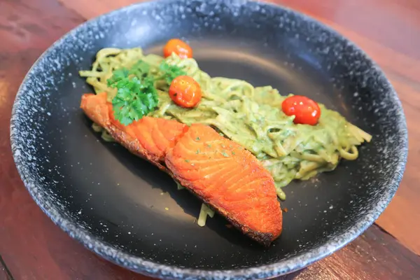 stock image pesto salmon pasta , pasta with green sauce or pesto sauce or salmon pasta