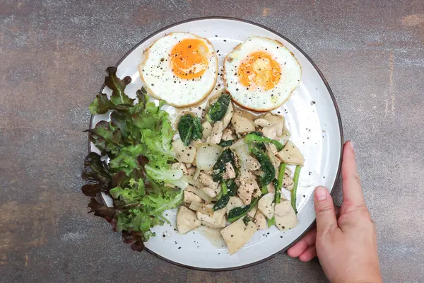 stock image stir-fried chicken with mushroom and kale , sunny side up egg and lettuce for serve