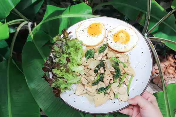 Stock image stir-fried chicken with mushroom and kale , sunny side up egg and lettuce for serve