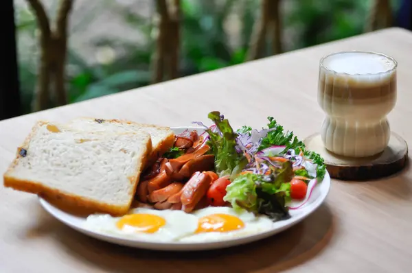 stock image breakfast or bread with sunny side up egg, sausage and vegetable and hot coffee for serve