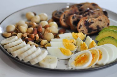 walnut cranberry sourdough bread or cranberry sourdough with boiled egg , avocado , banana and nuts for serve clipart