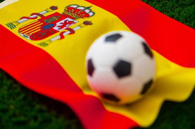 İspanya Milli Futbol Takımı. Ulusal Bayrak yeşil çimlerde ve futbol topunda. 2022 yılında şampiyonluk ve turnuva için futbol duvar kâğıdı. Dünya çapında maç.