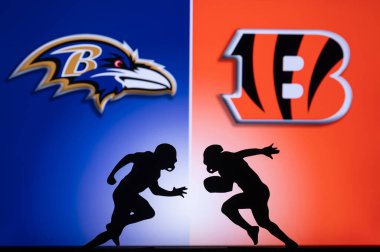 CINCINNATI, USA, JANUARY 10, 2023: Baltimore Ravens vs. Cincinnati Bengals. NFL Wild Card Round 2023, Silhouette of two NFL American Football Players against each other. Big screen in background