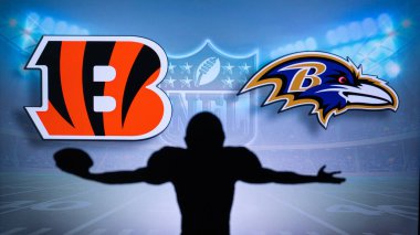 CINCINNATI, USA, JANUARY 10, 2023: Baltimore Ravens vs. Cincinnati Bengals. NFL Wild Card Round 2023, Silhouette of NFL player of american football. holding ball in hand. Big screen in background