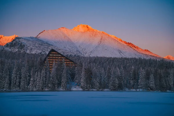 The High Tatras and Strbske pleso lake in all its frozen splendor, bathed in the light of a winter sunrise