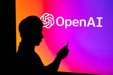 UK, LONDON. JANUARY 30, 2023: The Power of Open AI's Artificial Intelligence Software, displayed through the Silhouette of a Man Holding a Smartphone