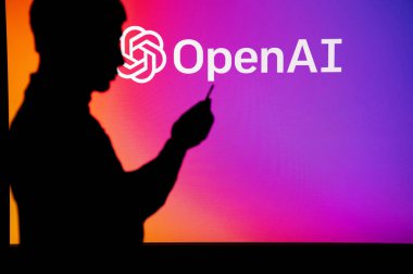 UK, LONDON. JANUARY 30, 2023: Open AI and the Advancements in Technology: Silhouette of Man Holding Smartphone