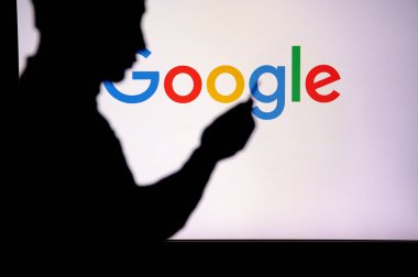 JAPAN, TOKYO. JANUARY 30, 2023: Google. Unleashing the Power of the Internet: Silhouetted Man Uses Innovative App to Browse