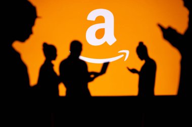 USA, WASHINGTON, JANUARY 30, 2023: Amazon. Web Development Dreams Come True: Silhouetted Developers in Discussion with Company Logo