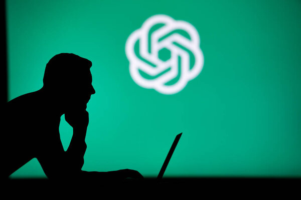 USA, NEW YORK CITY, JANUARY 30, 2023: The Future of Technology in the Palm of His Hand: Silhouette of Man with AI Software Logo