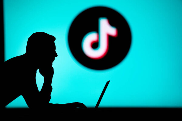 JAPAN, TOKYO. JANUARY 30, 2023: TikTok. Unleashing the Power of the Internet: Silhouetted Man Uses Innovative App to Browse