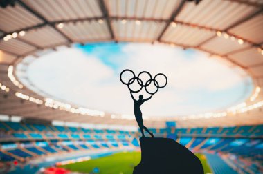 PARIS, FRANCE, 7 Temmuz 2023: Atletizm Uyumu: Atletizm Heykeli Modern Olimpiyat Stadyumuna Karşı Olimpiyat Çemberini Sardı. Paris 2024 Yaz Olimpiyatları için Spor Fotoğrafı.