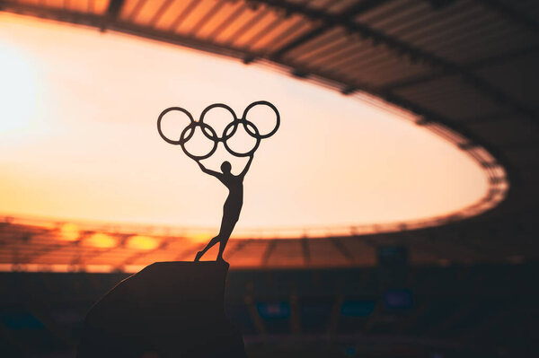 PARIS, FRANCE, JULY 7, 2023: Inspiring Strength: Statue of Female Athlete Elevates Olympic Circle at Modern Olympic Stadium. Sports Photo for Paris 2024 Summer Olympic Games.