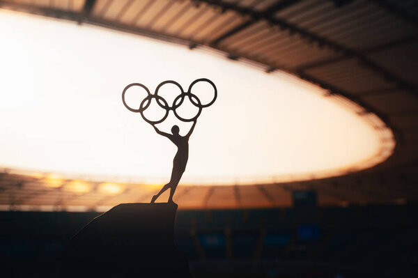 PARIS, FRANCE, JULY 7, 2023: Inspiring Strength: Statue of Female Athlete Elevates Olympic Circle at Modern Olympic Stadium. Sports Photo for Paris 2024 Summer Olympic Games.