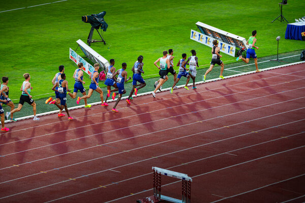 OSTRAVA, CZECHIA, JUNE 27, 2023: Male Runners Competing in 1500m Race: Athletes Navigate the Track and Field Course for Worlds in Budapest and Summer olympic Games in Paris