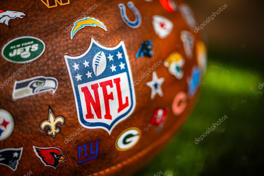 NEW YORK, USA, SEPTEMBER 11, 2023: NFL Game Ball, Logo in Focus and logos of all other teams of National Football league