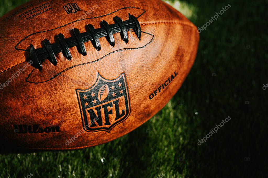 NEW YORK, USA, SEPTEMBER 11, 2023: NFL background photo. Ball placed on green grass in beautiful light.