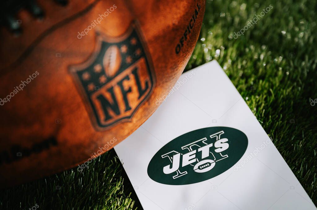 NEW YORK, USA, SEPTEMBER 11, 2023: New York Jets logo on the ground and official NFL ball on green grass. Jets card, edit space
