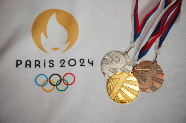PARIS, FRANCE, JANUARY 4. 2024: Paris 2024 Summer Games Memorabilia: White Blanket Presentation of Gold, Silver, and Bronze Medals with Official Logo