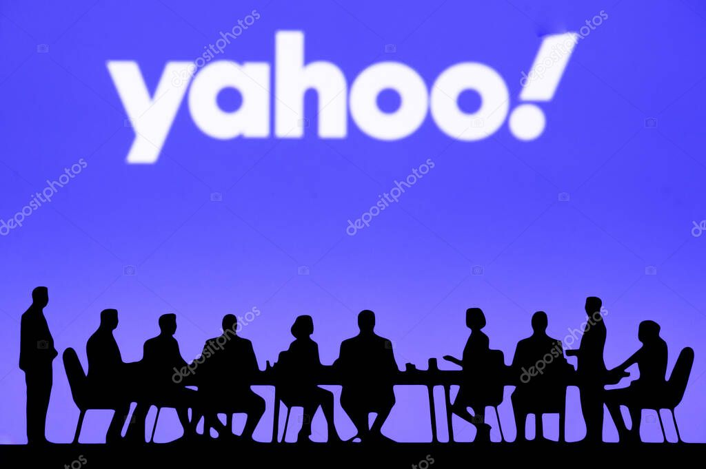 SUNNYVALE, USA, OCTOBER 10, 2024: Yahoo Executive Roundtable Discussion. High-level business leaders gathered around a table, exchanging ideas to boost revenue, with company branding on display.