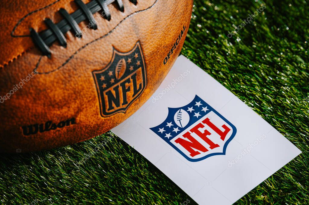 NEW YORK, USA, FEBRUARY 10, 2025: National Football League (NFL) Logo and American football ball on Green Grass.