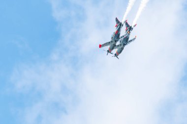 Leszno, Poland - June, 22, 2024: Antidotum Airshow Leszno, PZL-130 Orlik, propeller training aircraft. The pilot performs acrobatics in the air, leaving a spectacular smoke behind the plane. clipart