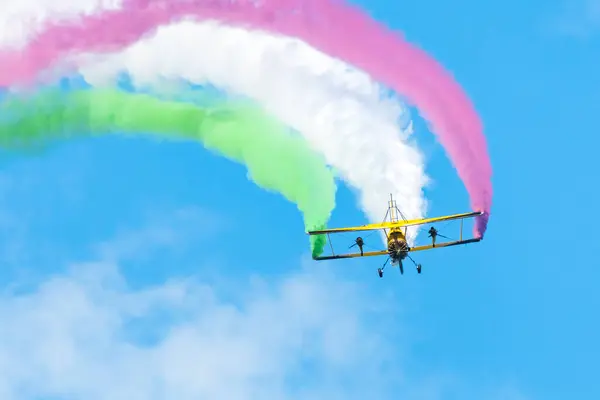 stock image Leszno, Poland - June, 22, 2024: Antidotum Airshow Leszno, Scandinavian Airshow Catwalk, Grumman G-164A Ag-Cat. Acrobats perform a show on the wings of a flying plane, colorful smoke behind the plane