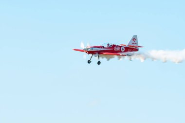 Leszno, Poland - June, 22, 2024: Antidotum Airshow Leszno, Zelazny Aerobatic Team, Zlin 50. The pilot performs acrobatics in the sky, they leave a spectacular smoke behind the plane. clipart