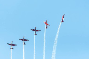 Leszno, Polonya - 22 Haziran 2024: Antidotum Airshow Leszno, PC-7 Team, Pilatus PC-7 uçağı. Pilotlar gökyüzünde akrobasi yapıyorlar, arkalarında muhteşem dumanlar bırakıyorlar.