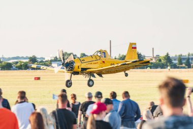 Leszno, Poland - June, 22, 2024: Antidotum Airshow Leszno, PZL M18 Dromader firefighting plane. The pilot lands at the field airport in front of the audience. clipart