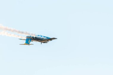 Leszno, Poland - June, 22, 2024: Antidotum Airshow Leszno, Nils Schylstrom in the Saab SK.60 plane. The pilot performs acrobatics in the air, leaving a spectacular smoke behind the plane. clipart