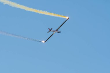 Leszno, Polonya - 22 Haziran 2024: Antidotum Airshow Leszno, Red Bull Blanix-Team Let L-13 Blanik uçağı. Pilot gökyüzünde akrobasi yapıyor, arkasında renkli dumanlar bırakıyor..